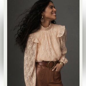 Anthropologie Porridge Sheer Lace Long-Sleeve Top in a peach/blush color.